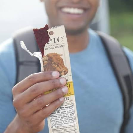 EPIC Wagyu beef snack strips: person holding an opened beef snack strip