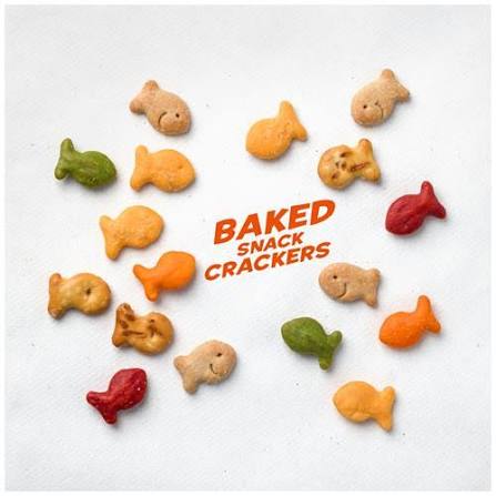 Assorted Goldfish crackers scattered on white background