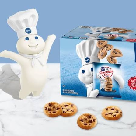 Pillsbury Doughboy beside cookie box and mini cookies
