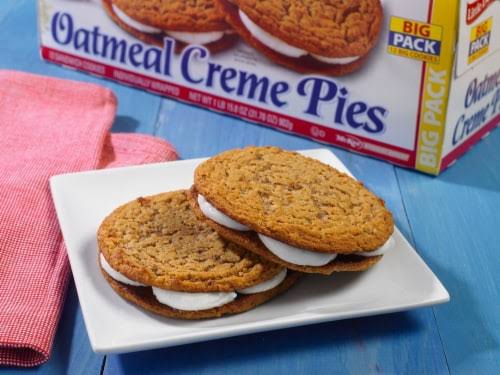 Little Debbie Oatmeal Creme Pies on a plate beside the Big Pack box.
