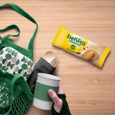 belVita Vanilla Mocha biscuit packs beside a tote bag and travel cup.