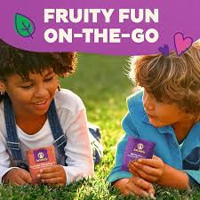 Children enjoying Annie's Organic Berry Patch Fruit Snacks outdoors.